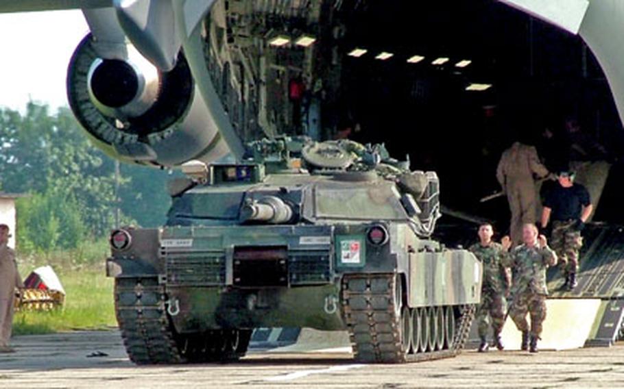 An American M1A1 Abrams tank rolls off an Air Force C-17 cargo plane Sunday on Bezmer Air Base, Bulgaria. The tank is one of several taking part in exercise Immediate Response 2005, in which 1st Armored Division and Bulgarian army soldiers are conducting NATO training.
