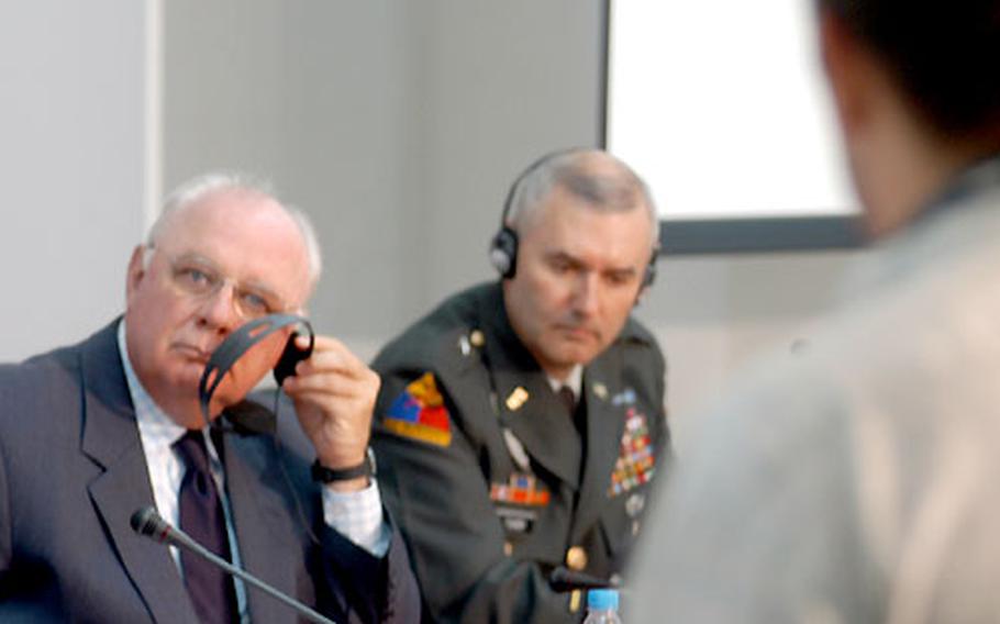 James Pardew, U.S. ambassador to Bulgaria, and Brig. Gen. Michael Tucker, 1st Armored Division assistant commander for maneuver, listen to a question from a Bulgarian newspaper reporter at a news conference Wednesday in Sofia, Bulgaria.