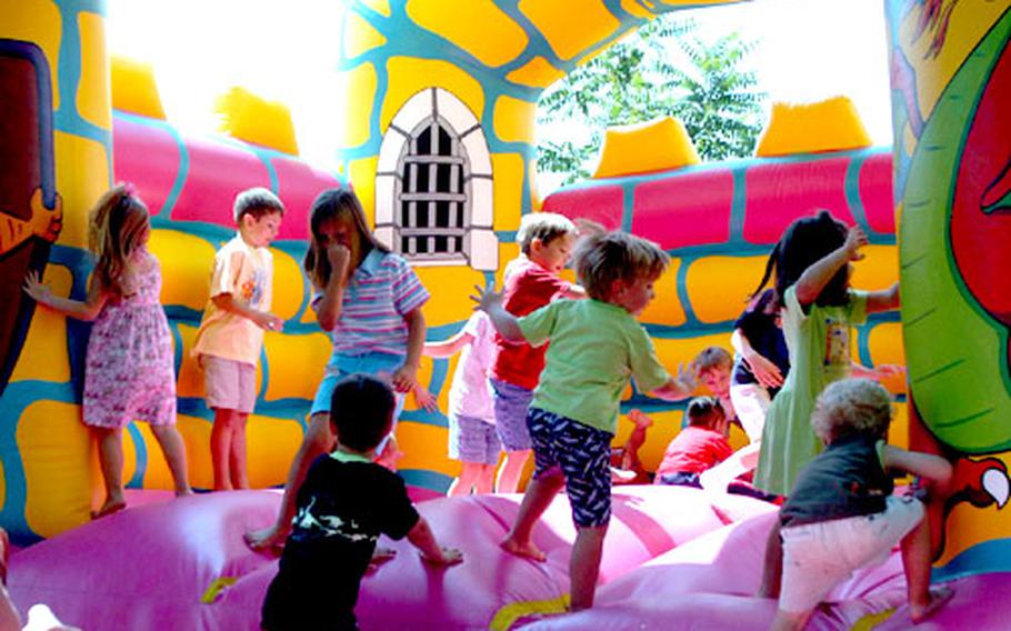 Wednesday was "Spouse It Up" day for folks at Aviano Air Base, Italy, but it looked like the kids were having the most fun. Here, a handful of them jump in an inflatable castle.