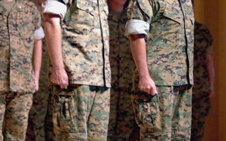 Lt. Gen. Robert R. Blackman Jr., left, stands next to Brig. Gen. Joseph V. Medina during a “Relinquishment of Command Ceremony” on Thursday evening at the Camp Foster Theater. Blackman handed the reigns of Marine Corps Bases Japan to Medina and III Marine Expeditionary Force to Brig. Gen. Christian B. Cowdrey until the Senate confirms a successor.
