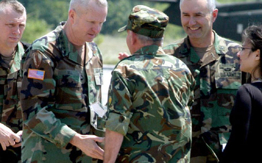 Gen. B.B. Bell, second from left, commander of U.S. Army Europe, greets Bulgarian Brig. Gen. Ventsislav Mladenov, center, with Brig. Gen. Michael Tucker, assistant division commander for 1st Armored Division, after Bell arrived Friday to visit training at the Novo Selo Training Area, Bulgaria.