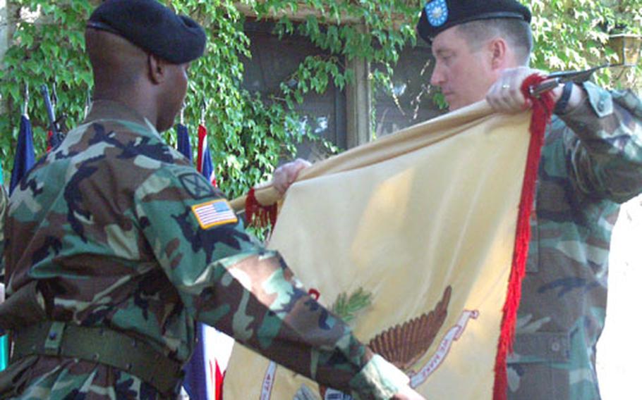 Lt. Col. Thomas Fass and Master Sgt. Christopher Tipton case the colors of the 417th Base Support Battalion at a ceremony Friday in Kitzingen, Germany.