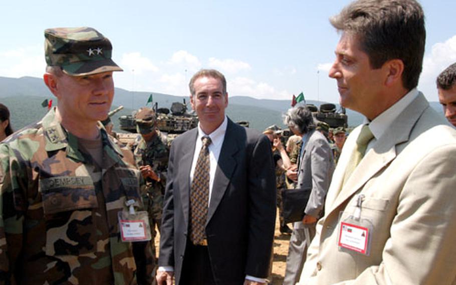 Bulgarian President Georgi Parvanov, right, talks with Maj. Gen. Martin Dempsey, commander of the 1st Armored Division, after watching a 30-minute live-fire exercise at the Novo Selo Training Area in Bulgaria. Jeffrey Levine, deputy chief of mission for the U.S. Embasssy in Bulgaria, center, also watched the exercises in which U.S. troops and Bulgarian soldiers are training at the Novo Selo Training Area.