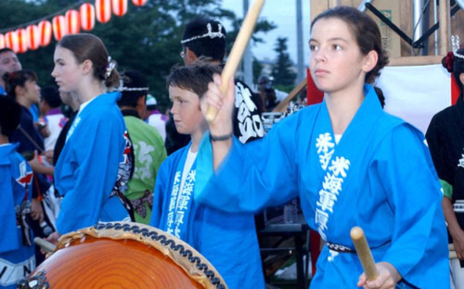 Megan Patten, daughter of Cmdr. Eric Patten, plays the Taiko drums during the 2004 Bon Odori festival at Naval Air Facility Atsugi.