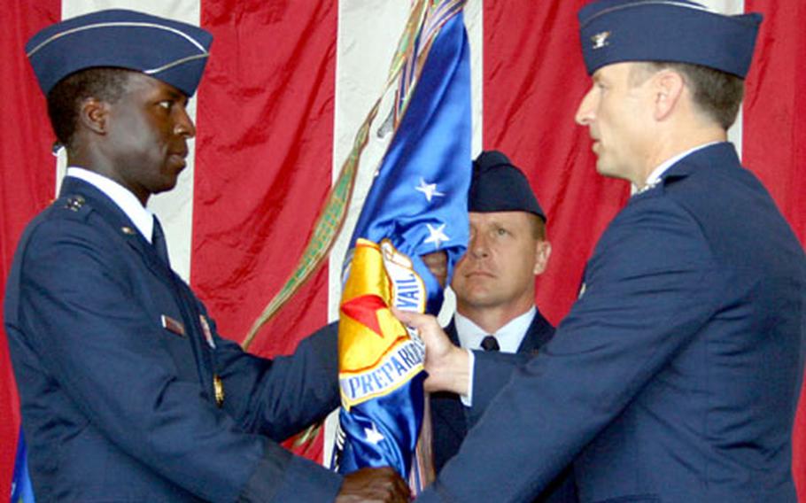 Maj. Gen. Edward A. Rice, left, commander of the 13th Air Force, presents the guidon of the 36th Air Expeditionary Wing to Col. Michael R. Boera during the change-of-command ceremony at Andersen Air Force Base, Guam, on Monday.