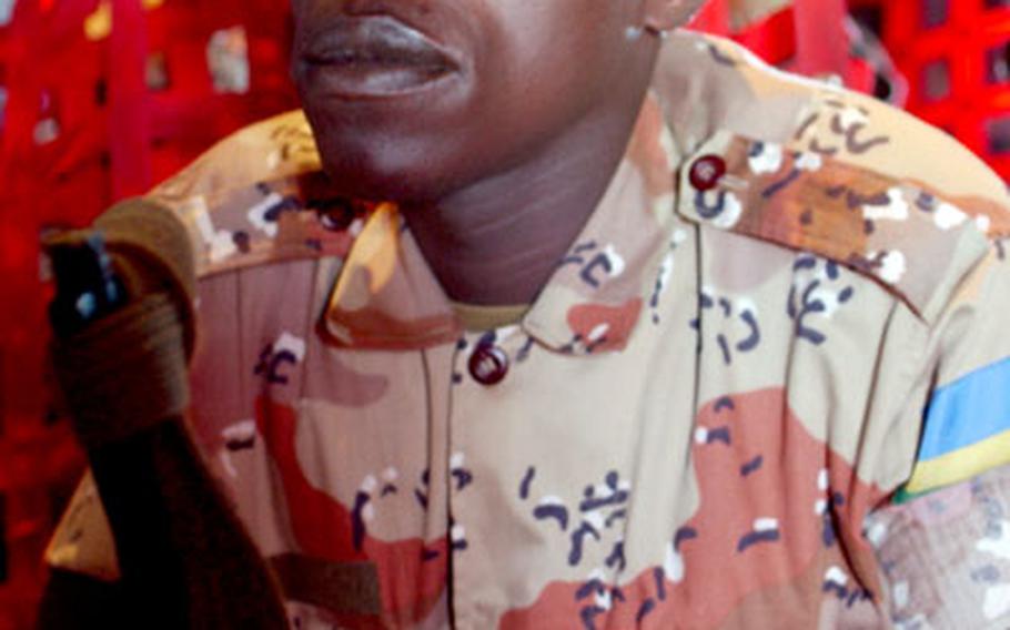Pvt. Baganwa Froduald, a member of the Rwandan forces, waits to land in Sudan.