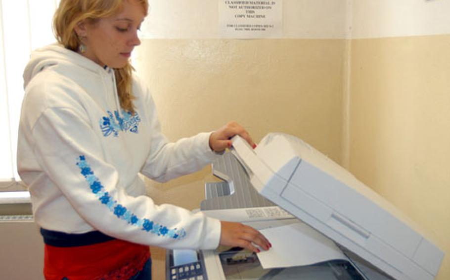 In this file photo from 2005, Ashlee Kozel, then 15, makes copies as part of her job as a Morale, Welfare and Recreation marketing assistant through the Summer Hire program in Bamberg, Germany. Kozel is one of 300 students in the 98th Area Support Group working six weeks of their summer to earn extra cash.