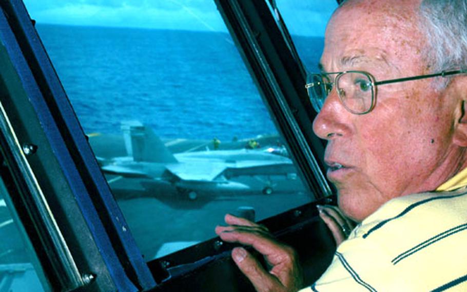 Retired Capt. Everett Southwick, former USS Kitty Hawk aviator and Vietnam prisoner of war, observes flight operations Wednesday from the Kitty Hawk’s flag bridge for the first time since 1967.