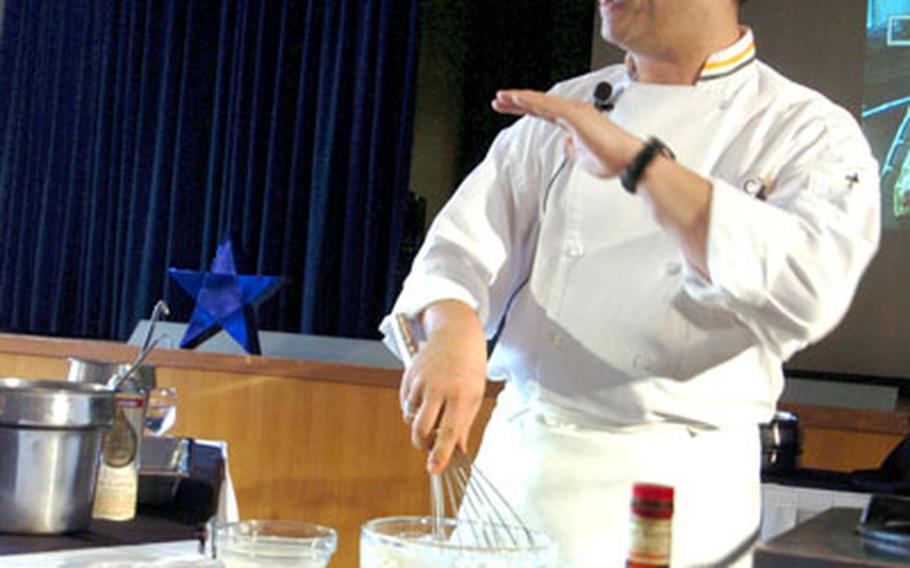 Stephan Miller explains how to make traditional crepes - thin pancakes, often with fillings - in front of guests at the culinery demonstration at Naval Air Facility Atsugi, Japan.