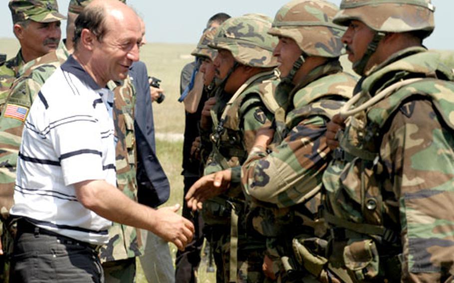 Romanian President Traian Basescu shakes hands with Texas National Guard soldiers from the 4th Battalion, 133rd Field Artillery out of New Braunfels, Texas, Sunday afternoon at the Babadag training area.