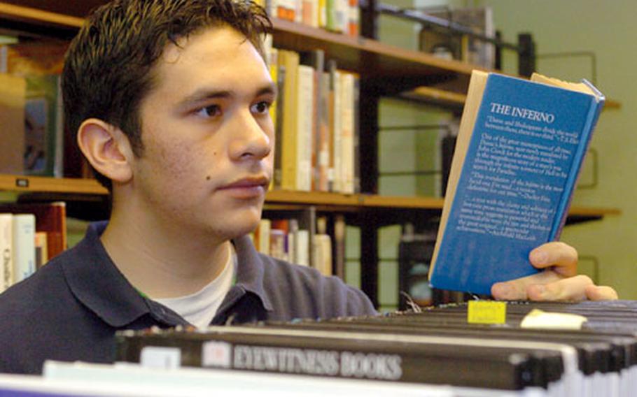 Jose Tovar Jr., an honor student, three-sport letterman and Congressional Award winner, checks out a book in the Bitburg High School library, where he assisted between classes. He will be attending classes at Georgetown University in the fall, marking the first time he has lived in the United States since he was one year old.