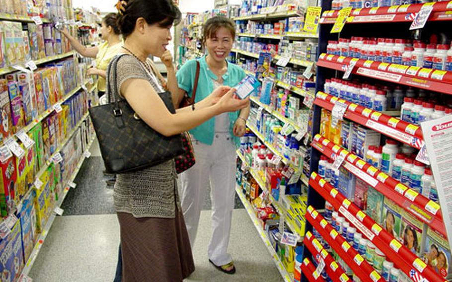 Teachers from Chilgok County check out the variety of products at the Camp Carroll commissary during a visit July 27.