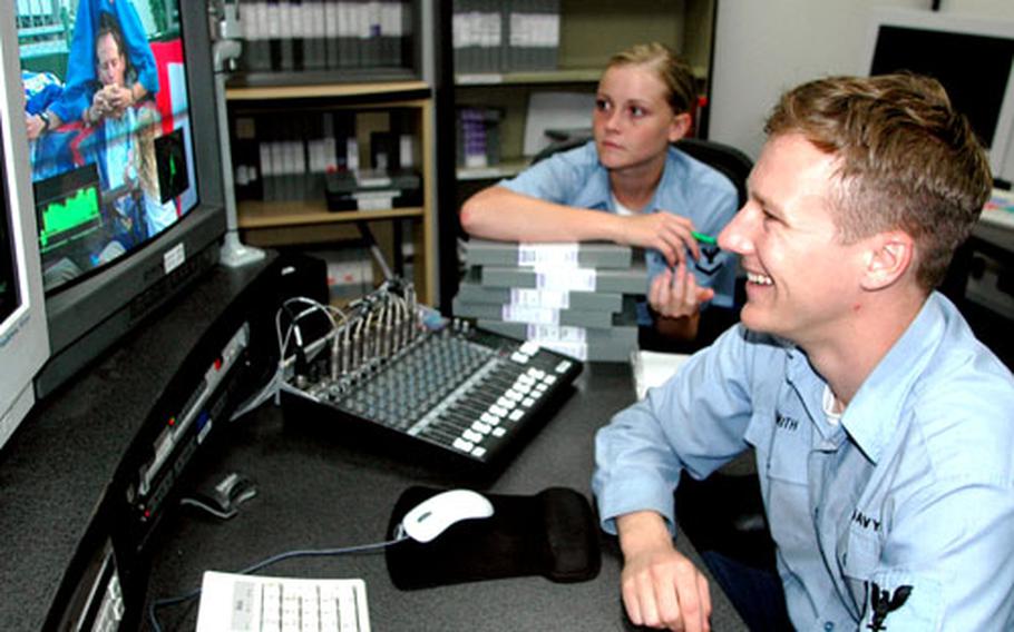 Petty Officer 3rd Class Beau Smith, news director for American Forces Network, Sasebo Detachment, edits a news report created by anchor Petty Officer 3rd Class Melanie Lemus on Tuesday at Sasebo Naval Base, Japan.