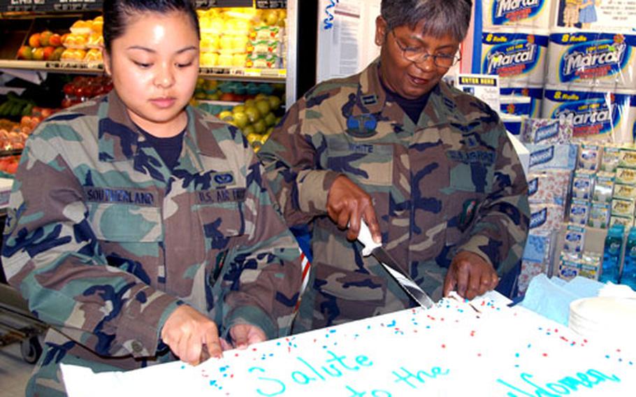 Airman Elizabeth Ann Southerland, left, and Capt. Jean White helped the Defense Commissary Agency at Misawa Air Base kick off the store’s sales promotion “A Salute to Women in the Military” on Monday. Southerland and White are the youngest and oldest women, respectively, on active duty at Misawa, according to base officials.