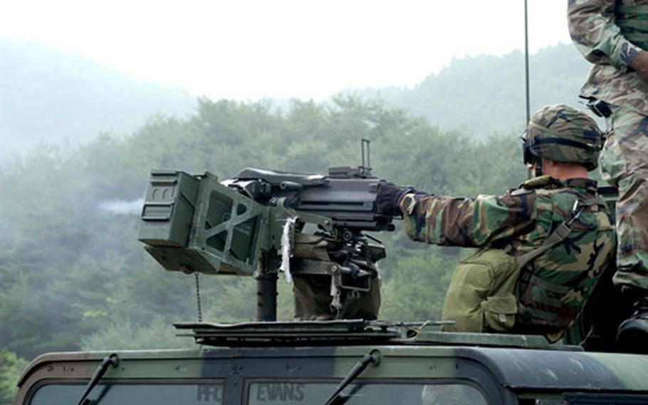 A 728th Military Police Battalion soldier fires a MK-19 machine gun at a live-fire range in South Korea last week. The weeklong training aimed at drilling the battalion in battle techniques drawn from the Iraq war.