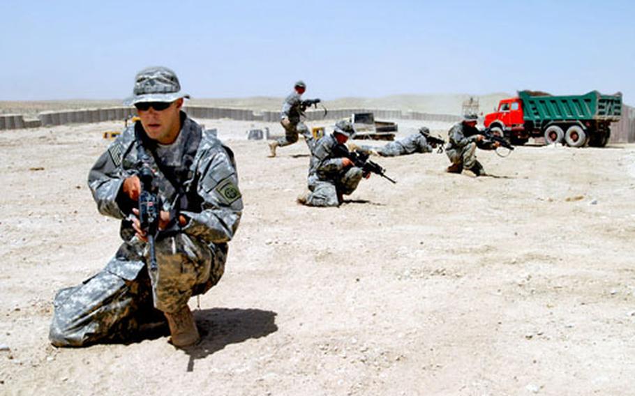 Spc. Kevin O’Flarity kneels during a squad training drill at Forward Operating Base Lagman in Afghanistan as other soldiers take up positions behind him. The soldiers, from Fort Bragg, N.C.-based 1st Battalion, 325th Airborne Infantry Regiment, recently moved into the area as U.S. forces bulk up to provide more security for September’s elections.