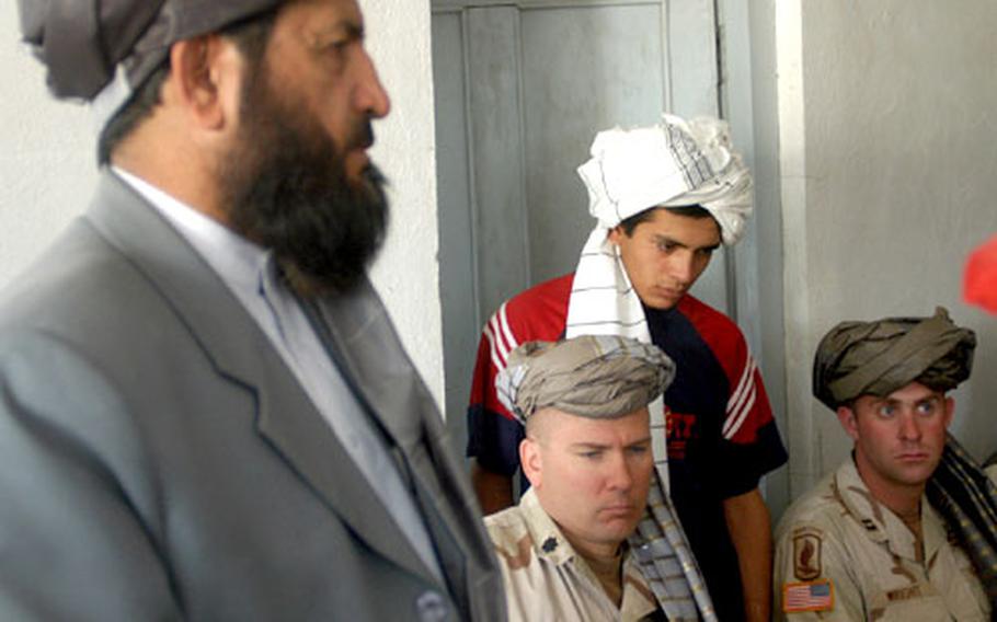 Dilber Armian, governor of Afghanistan's Zabol Province, speaks to residents of Shinkay, Afghanistan, Wednesday, during a visit to the town and a shura (traditional Afghan gathering) with local leaders. Accompanying Armian were Capt. Benjamin Wright, commander of Company A, 2nd Battalion (Airborne), 503rd Infantry Regiment, and battalion commander Lt. Col. Mark Stammer, who were given traditional Afghan head coverings for the shura.