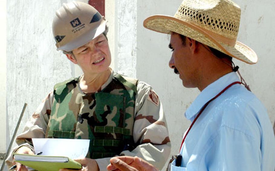 Donna Street, left, Kirkuk area engineer, speaks with contractor Shapoor Amin on Tuesday at a border fort in Khormal, Iraq. Engineers from the Corps of Engineers-Kirkuk region visit the numerous construction sites in the region to check on the workers’ progress, though often that progress has been particularly slow.