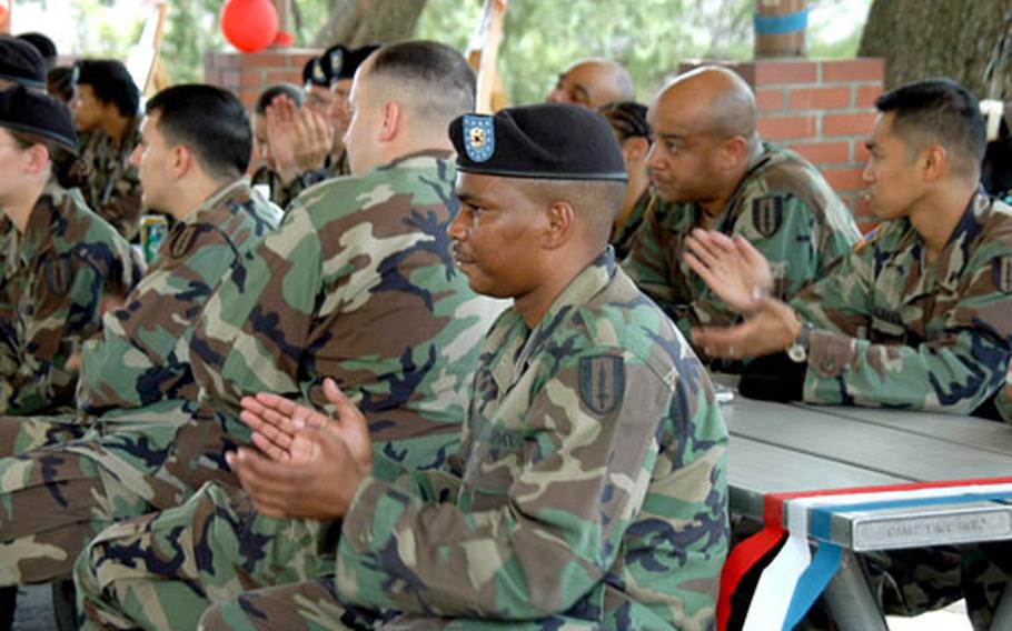 Soldiers from the 41st Battalion of the 1st Signal Brigade listen to the brigade’s senior retention officer at a barbecue picnic Thursday afternoon.