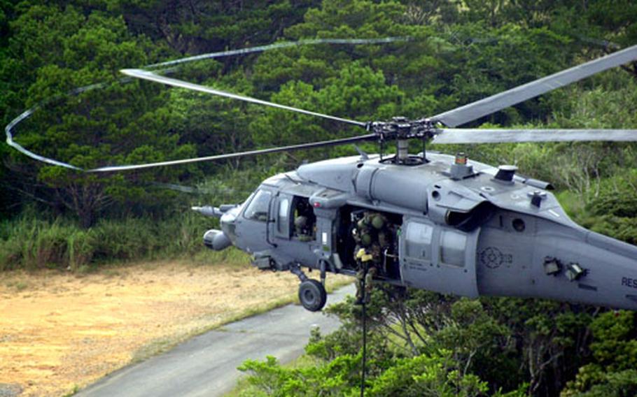 Members of the 33rd and 31st Rescue Squadrons, shown above during a recent exercise, rescued a 19-year-old American surfer Friday night after the youth had been swept to sea, victim of a rip tide in waters choppy from the nearby passing of Typhoon Matsa.