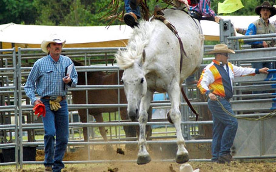 Novice cowboy Robert Blair takes a ride on a bronc at a rodeo in Stuttgart, Germany.