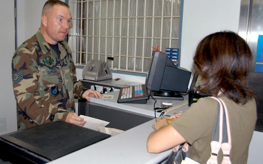 Tech. Sgt. Andrew Dapkins, custodian of postal effects for the 35th Communications Squadron, helps a customer at the Misawa Post Office’s finance window Tuesday afternoon. The post office is almost fully staffed again after being without several personnel this spring and summer.