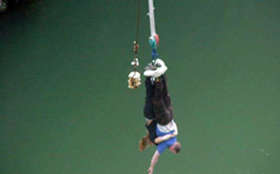A servicemember from Misawa Air Base, Japan, hangs from a bungee jump near Sendai, Japan, during a May excursion with Single Airman Xtreme.