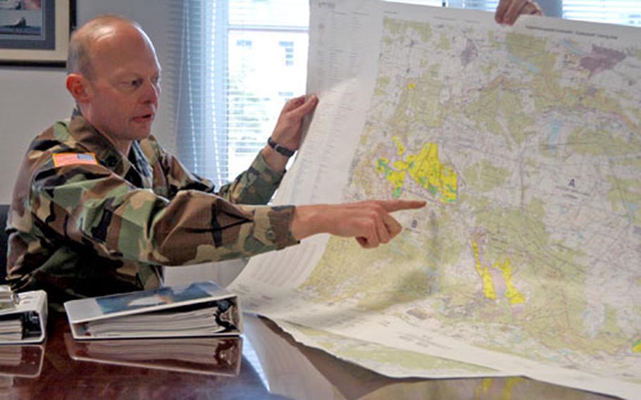 Lt. Col. Robert Shoemaker, chief of Grafenwöhr Training Area range operations, points to sites on a map of the training area.