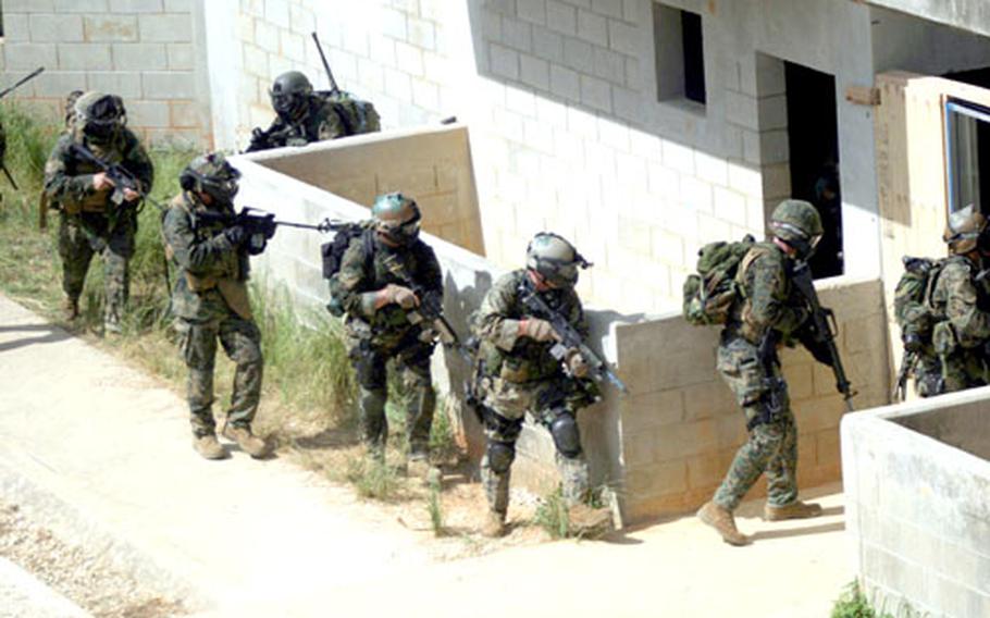 Marines with the 31st Marine Expeditionary Unit’s Maritime Special Purpose Force enter a building in the Central Training Area on Okinawa as part of a Training in an Urban Environment exercise last week.