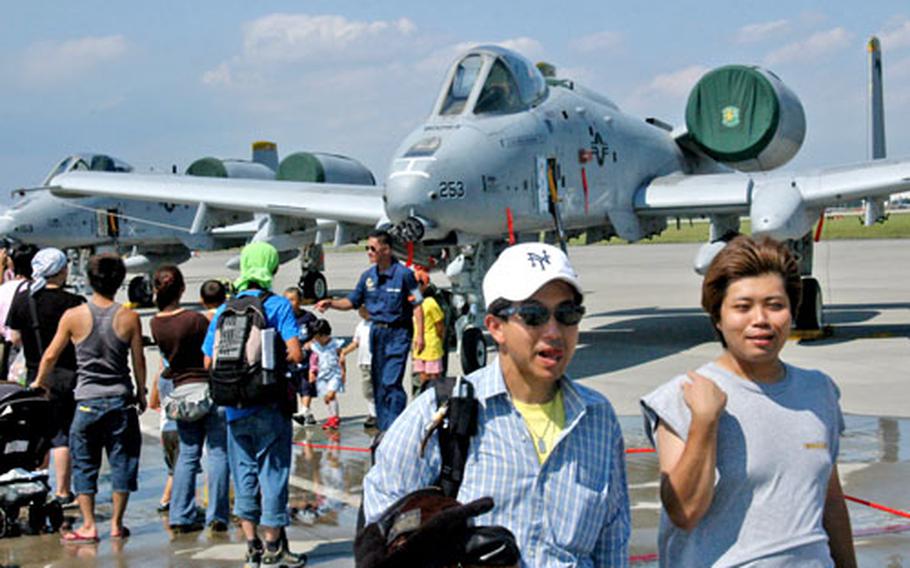 Japanese visitors check out an A-10 Warthog among the many aircraft displays Saturday at the annual Japanese-American Friendship Festival on Yokota Air Base.