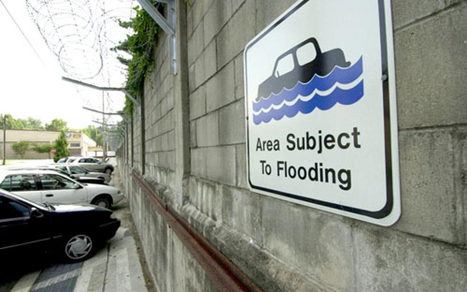 Signs like this one, near the bowling alley on Yongsan Garrison, South Korea, warn community members not to park in low-lying areas during monsoon season, which runs through the end of August.