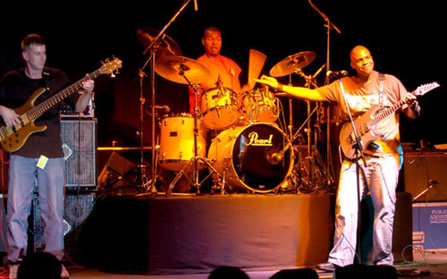 From left, Warren Mixon, Jason McElveen, and Scott Taylor of the band Strike Force perform an original instrumental song at the Installation Management Agency-Europe’s 26th Annual Battle of Bands talent contest in Katterbach, Germany, on Saturday. The trio took first place in this year’s competition.