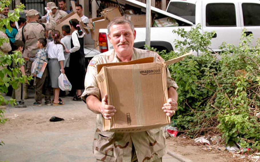 Robert Oney Pruett, administrative specialist with the Corps of Engineers Gulf Region District, delivers school supplies in Baghdad.