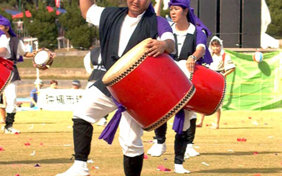 Americans and other foreign nationals engage in 2001’s annual All-Island Eisa Festival in Okinawa City as part of the Okinawa International Exchange Club. The 2005 festival will take place this weekend.
