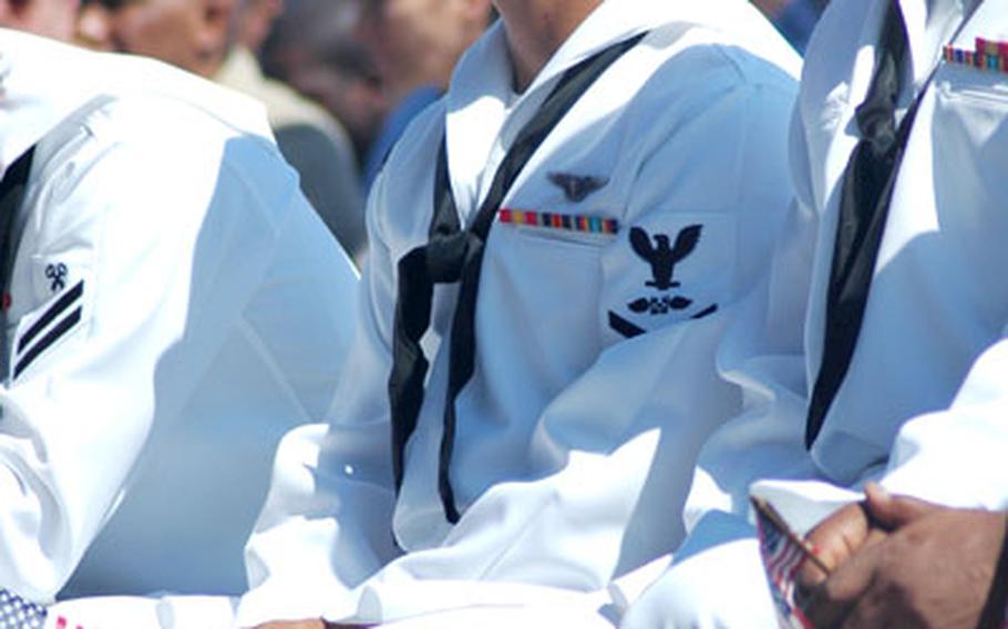 Petty Officer 3rd Class Jorge Duarte-Figueroa from Guadalajara, Mexico, waits with fellow sailors for a citizenship ceremony to commence on the flight deck of the USS Kitty Hawk at sea on Saturday.