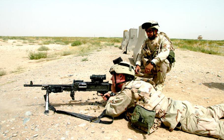 Staff Sgt. Carlos Navas watches as Spc. Mike Lehmiller fires an M-240B machine gun at the Kandahar Airfield, Afghanistan, range. Lehmiller was one of four soldiers from Company B, 2nd Battalion, 503rd Parachute Infantry Regiment who was killed Sunday by a roadside bomb.