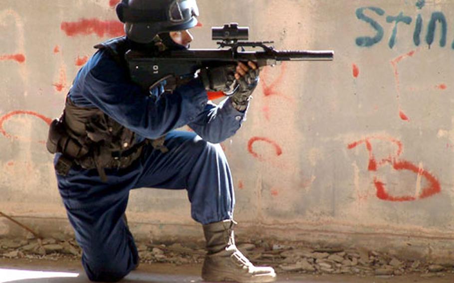 A Japanese war-game player stalks his prey during an outing in the ruins of a hotel on Okinawa. War games with BB guns are popular on Okinawa, but Okinawa City officials are objecting to Americans using a city park for their games.
