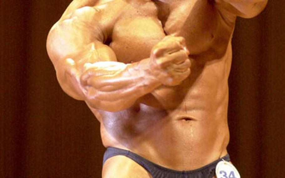 Marine Sgt. Maj. Robert Caldwell shows off his massive arms. He took first in the men’s heavyweight division.