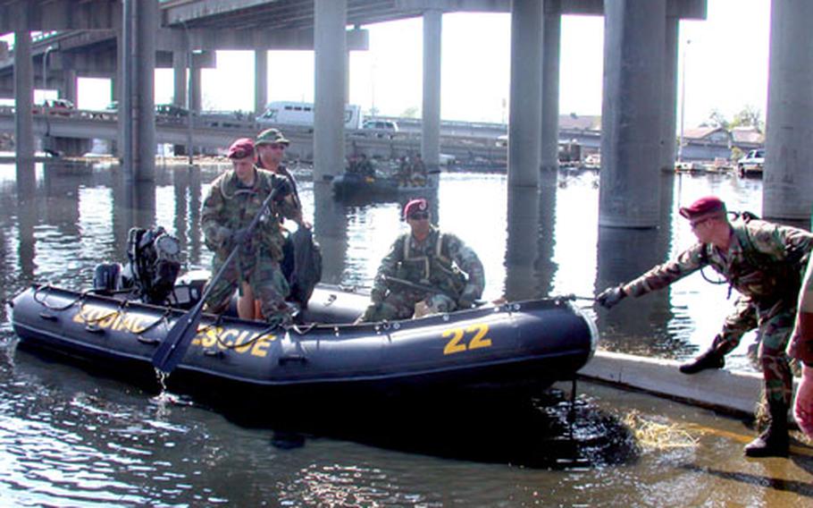 Soldiers from the 82nd Airborne Division’s 307th Engineering Battalion come back to land after a house-by-house search for survivors in a flooded section of New Orleans west of downtown Thursday.