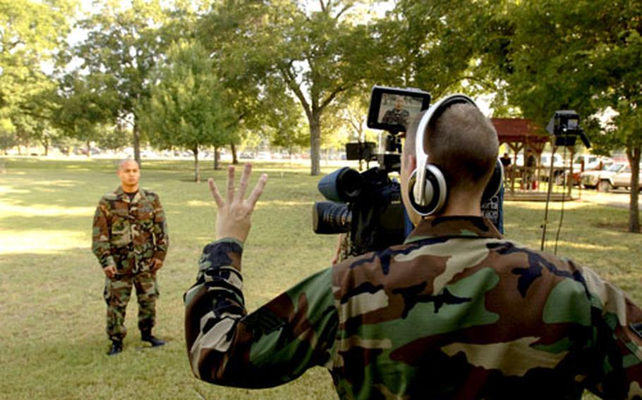 Senior Airman Ryan Nelson tapes a mock holiday greeting during a training session in San Antonio. Four teams from the Army and Air Force Hometown News Service will soon travel to about 70 overseas installations, including 10 forward-deployed locations, to tape messages from Department of Defense ID cardholders stationed overseas to families and friends in the States.