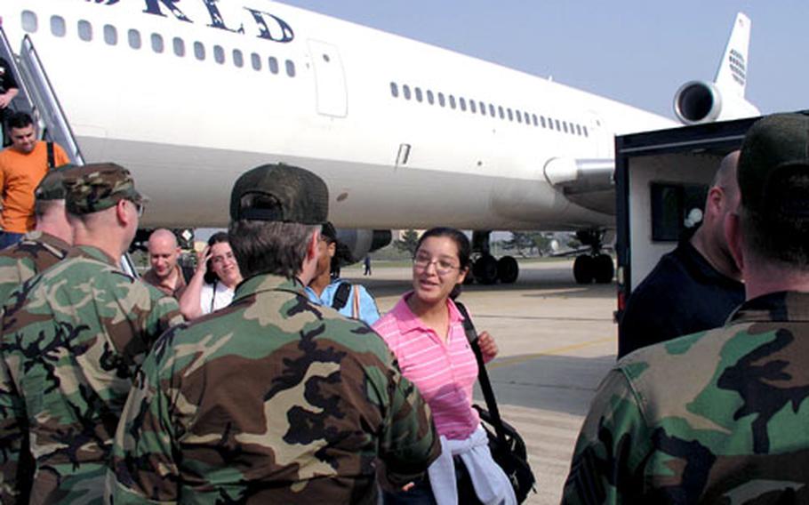 Airmen are greeted as they arrive at Kunsan Air Base in South Korea aboard a chartered Patriot Express flight.