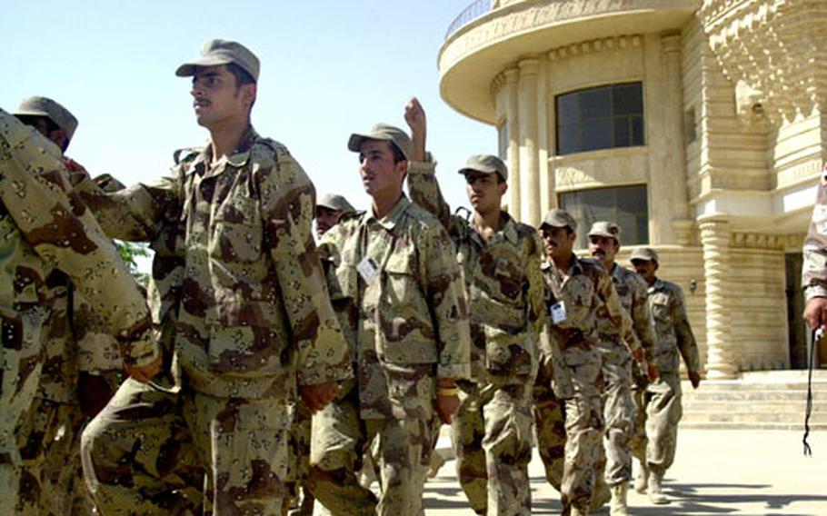 Iraqi Army trainees march Saturday at “Iraqi Island” on Forward Operating Base Danger in Tikrit, Iraq, as part of their basic training. Trainees spend four weeks learning soldiering skills under Iraqi drill instructors who have been trained by U.S. soldiers.