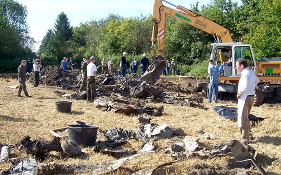 Members of Danny Keay’s World War II aircraft recovery team work on a site containing the remains of a P-47 Thunderbolt and its pilot near Dortmund, Germany, this summer.