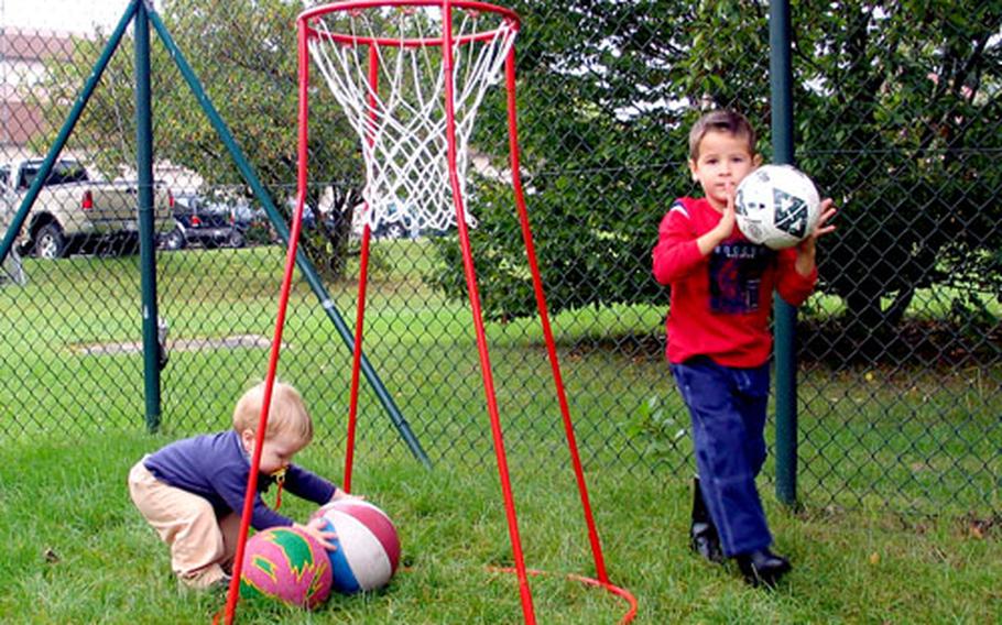 Scotty MacDonald, left, and Kevin Hammer play at the hourly child-care facility playground on Warner Barracks in Bamberg, Germany, on Sept. 5. The new program lets children learn through playing.