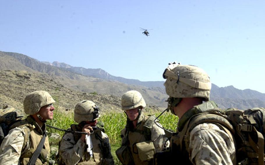 U.S. Marines with Company F, 2nd Battalion, 3rd Marine Regiment, 3rd Marine Division, out of Hawaii, speak with Apache helicopter pilots Thursday shortly after the Marines were attacked in eastern Afghanistan’s Laghman province. The mortar sailed past the Marines’ position, and no one was injured.