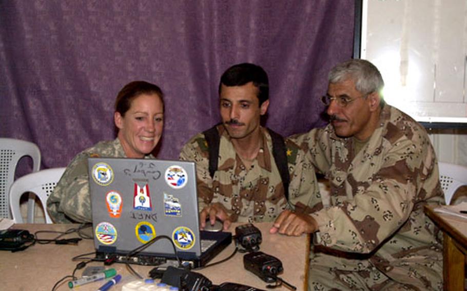 Sgt. 1st Class Janet Baldridge, left, teaches Iraqi soldiers about new communications software at the Iraqi army’s 4th Division compound, formerly known as Forward Operating Base Dagger, in Tikrit, Iraq.