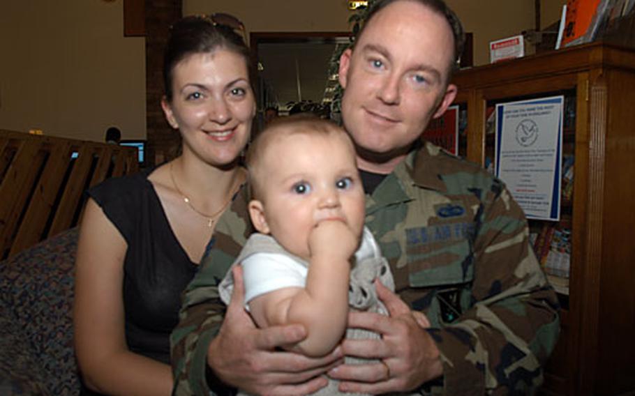 Tech. Sgt. Dan Ostrom and his wife, Sandra Ostrom, sit with their 6-month-old son, Justin. The exchange rate has caused the Ostroms to cut back since they arrived in England from McGuire Air Force Base in New Jersey in June.