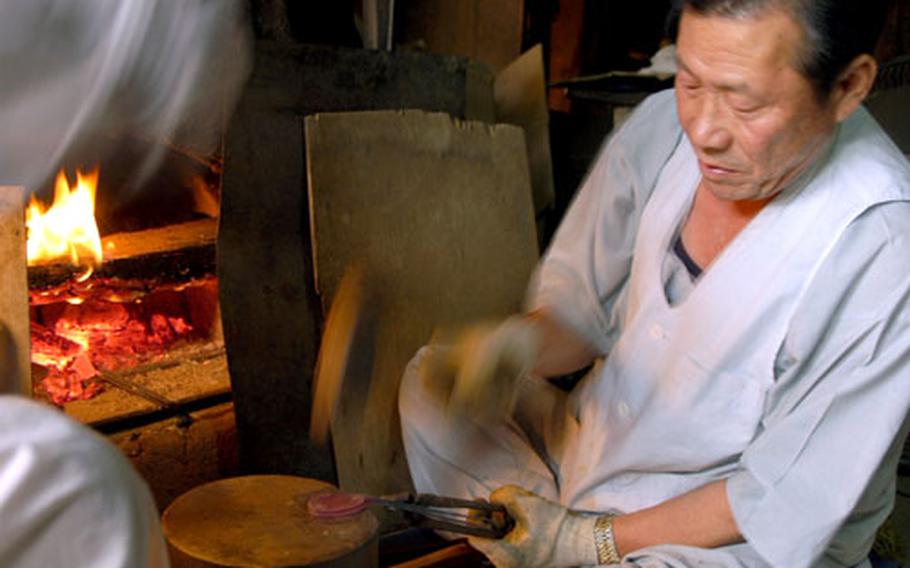 On “workshop street,” men use fire and mallets to shape metal into spoons. Other exhibits include silk-spinning, paper-making, embroidery and cooking.