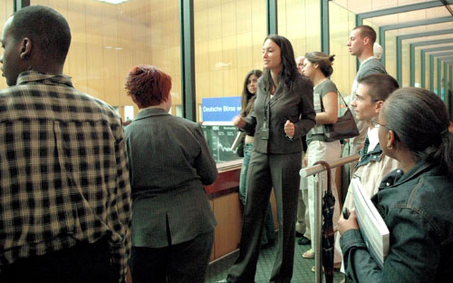 Rebecca Schmidt, center, of the Deutsche Börse legal department explains the Frankfurt stock exchange floor to University of Maryland students during their tour of the exchange.