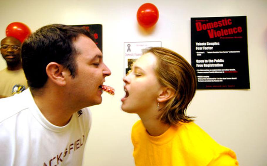 Beau and Annah Veazey, both teachers at Yokota Middle School, eat octopus as part of a couples fear factor challenge at Yokota Air Base, Japan, on Saturday. The event was hosted by Yokota’s Family Advocacy Program as a way to enhance public awareness and help stem domestic abuse within the military community.